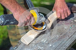 Mature Male Handles Angle Grinder Wooden