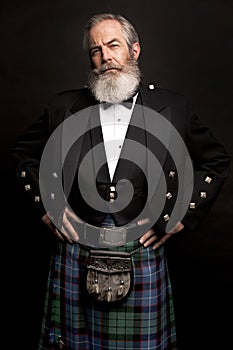 Mature male model wearing kilt with grey hairstyle and beard