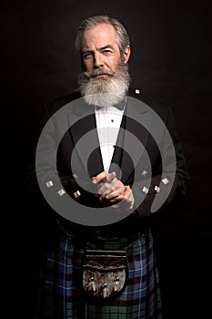 Mature male model wearing kilt with grey hairstyle and beard