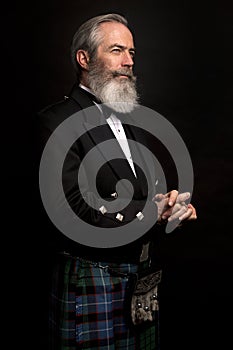 Mature male model wearing kilt with grey hairstyle and beard photo