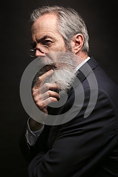 Mature male model wearing suit with grey hairstyle and beard