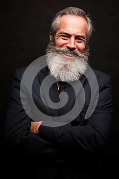 Mature male model wearing suit with grey hairstyle and beard