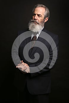 Mature male model wearing suit with grey hairstyle and beard