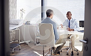 Mature Male Patient In Consultation With Doctor In Office