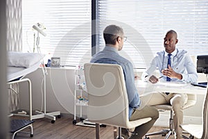 Mature Male Patient In Consultation With Doctor In Office