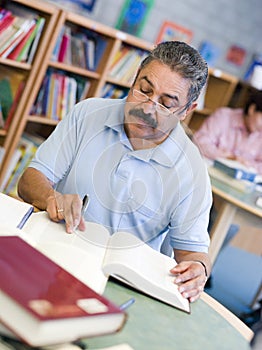 Mature male student studying in library