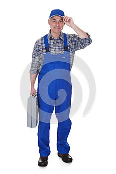 Mature male technician holding worktool