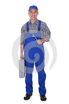 Mature male technician holding worktool photo