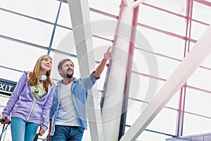 Mature man arriving with his daughter in airport looking for their pick up