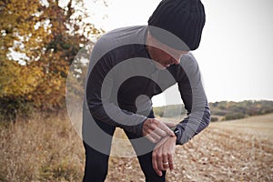 Mature Man On Autumn Run Around Field Checks Activity Tracker