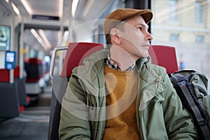 Mature man with backpack in a tram