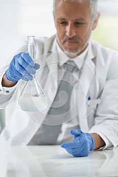 Mature man, beaker or scientist in lab for science innovation, vaccine or antiaging medicine chemical. Life extension