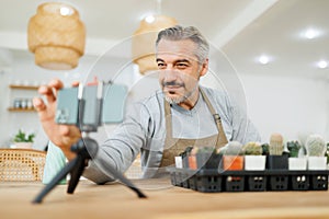 Mature man blogger having live streaming on smartphone