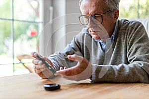 Mature Man Checking Blood Sugar Level