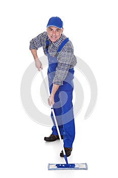 Mature man cleaning floor with mop