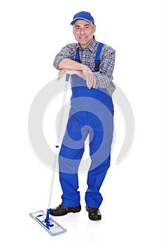 Mature man cleaning floor with mop