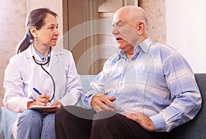 Mature man complaining to doctor about feels