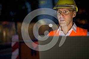 Mature man construction worker at the construction site in the c