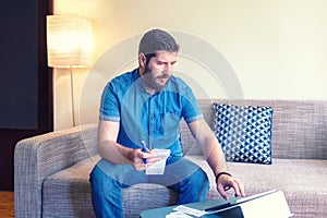 Mature man doing home finance online using digital tablet