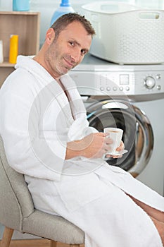 mature man doing morning laundry photo