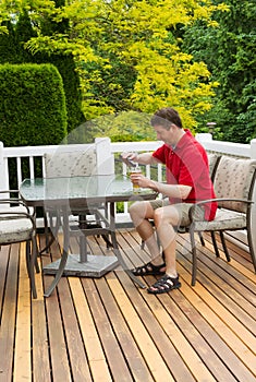 Mature man drinking beer outdoors