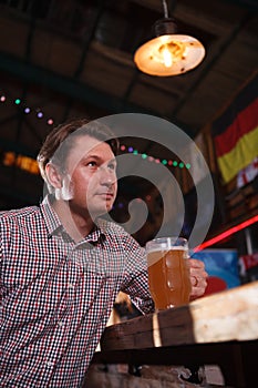 Mature man drinking beer at the pub