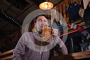 Mature man drinking beer at the pub