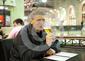 Mature man drinks beer