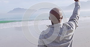 Mature man enjoying time outside by the sea