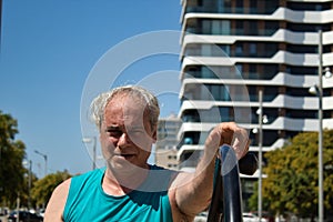 mature man doing sports in the city with sports machine