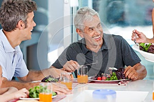 Mature man with family dinner table