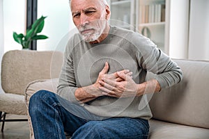 mature man feeling cardiac pain in chest