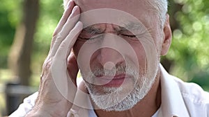 Mature man feeling sudden sharp pain in head, migraine attack, risk of thrombus