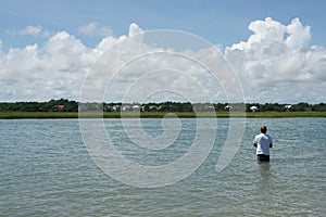 Mature man fishing alone in bay