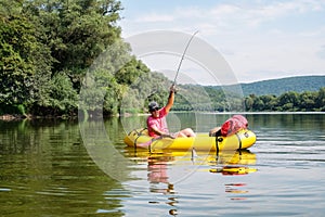 Mature man fishing from the packraft