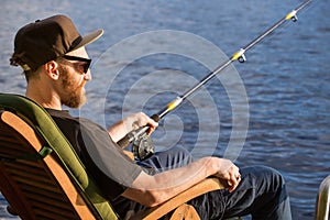 Mature man fishing from pier