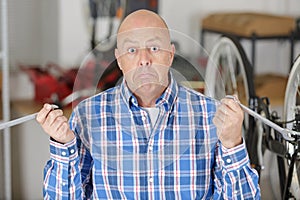 mature man fixing bike