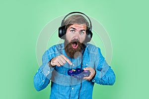 mature man gamer play computer games. guy with beard playing video games. brutal caucasian hipster with moustache. relax