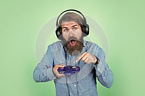 mature man gamer play computer games. guy with beard playing video games. brutal caucasian hipster with moustache. relax