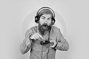 mature man gamer play computer games. guy with beard playing video games. brutal caucasian hipster with moustache. relax