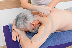 mature man getting back massage in