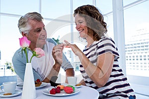 Mature man gifting ring to woman