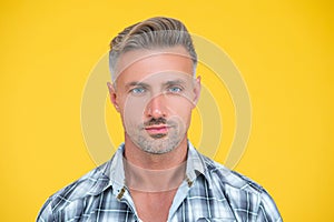 mature man with grizzle hair on yellow background