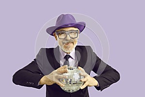 Mature man in hat and glasses with disco ball