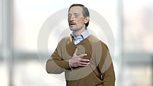 Mature man having heart-attack.