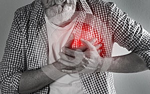 Mature man having heart attack on light background, closeup