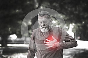 Mature man having heart attack in park