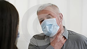 Mature Man Having Sore Throat Talking With Female Doctor Indoor