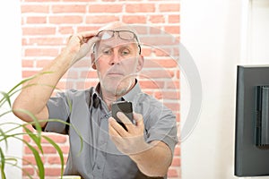 Mature man having trouble seeing phone screen