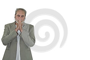 mature man with headphones and beard in suit pray on a white background